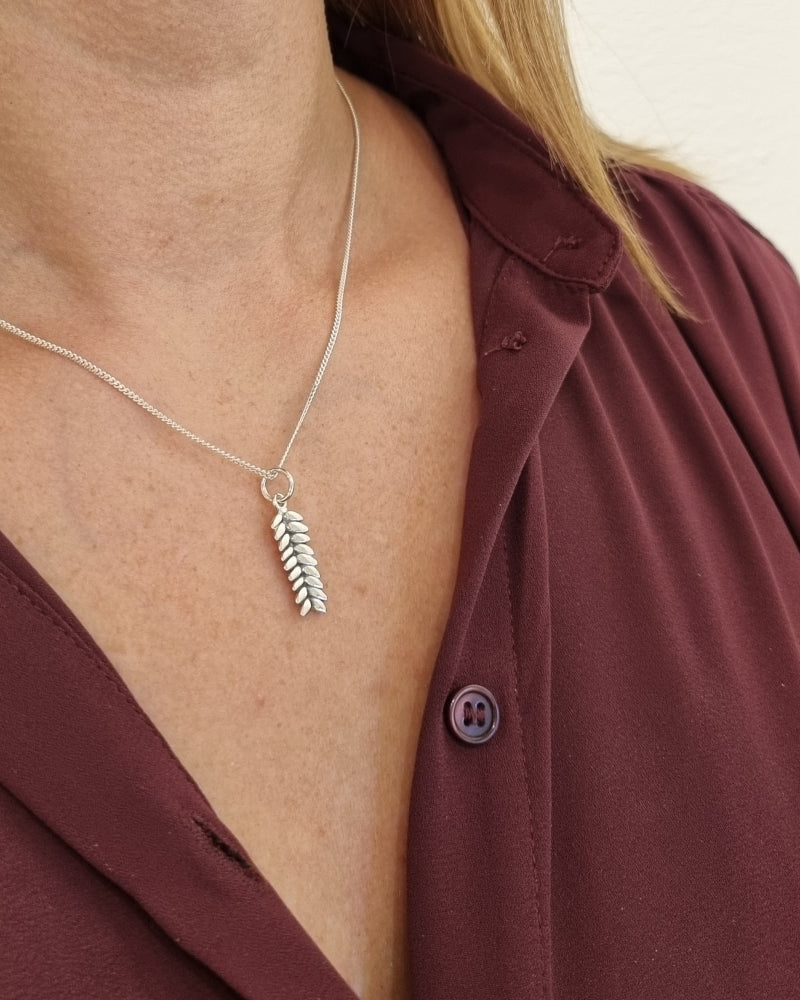 Guldviva Råg XS halsband runt halsen: halsbandet sträcker sig över bröstet.