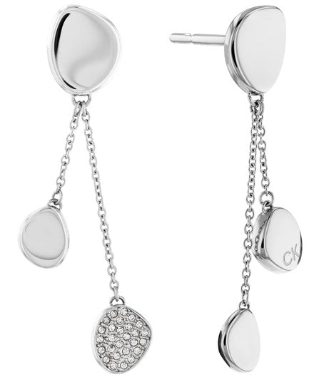 Calvin Klein Enchant CKJ35000211 örhängen har en stiftknäppning. Smycket består av tre tillplattade pärlor, varav två hänger från den tredje med hjälp av tunna kedjor. Örhängena är silverfärgade och en av de dinglande pärlorna i det andra örhänget är täckt med zirkoner.