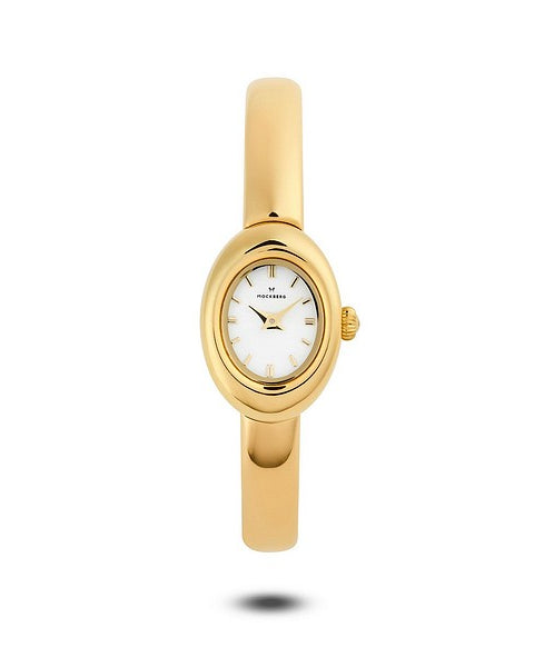 Guldfärgad Mockberg Belle Oval Petite Gold MB1769 damklocka med en sofistikerad oval boett, vit oval urtavla och ett smalt, stelt armband i armringsmodell.