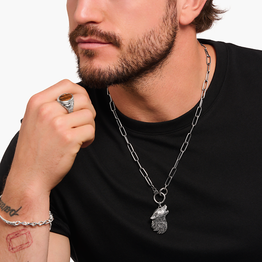 Thomas Sabo Howling Wolf With Stones PE966-643-21 hänge på en grov kedja runt en mans hals.