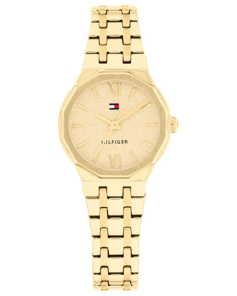 Guldfärgad Tommy Hilfiger TH1782886 damklocka med smäcker 25 mm boett, stållänk och en unik 12-kantig mutterformad lynett.