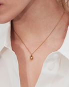 Kullattu Edblad Drop Mini Necklace Gold -kyynelkaulakoru mallin kaulalla