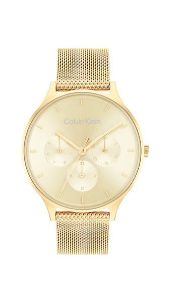 Calvin Klein Timeless Multifunction CK25200103 damklocka har en champagnefärgad urtavla med datum- veckodag- och 12/24h visning och guldfärgade index och visare. Ramen och remmen är också guldfärgade.