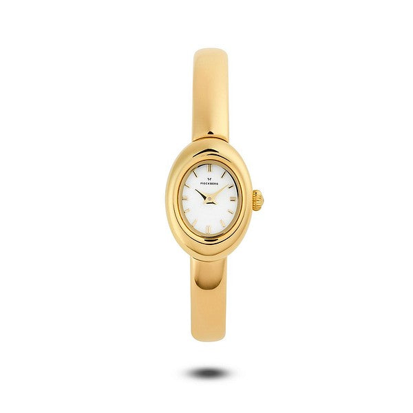 Guldfärgad Mockberg Belle Oval Petite Gold MB1769 damklocka med en sofistikerad oval boett, vit oval urtavla och ett smalt, stelt armband i armringsmodell.