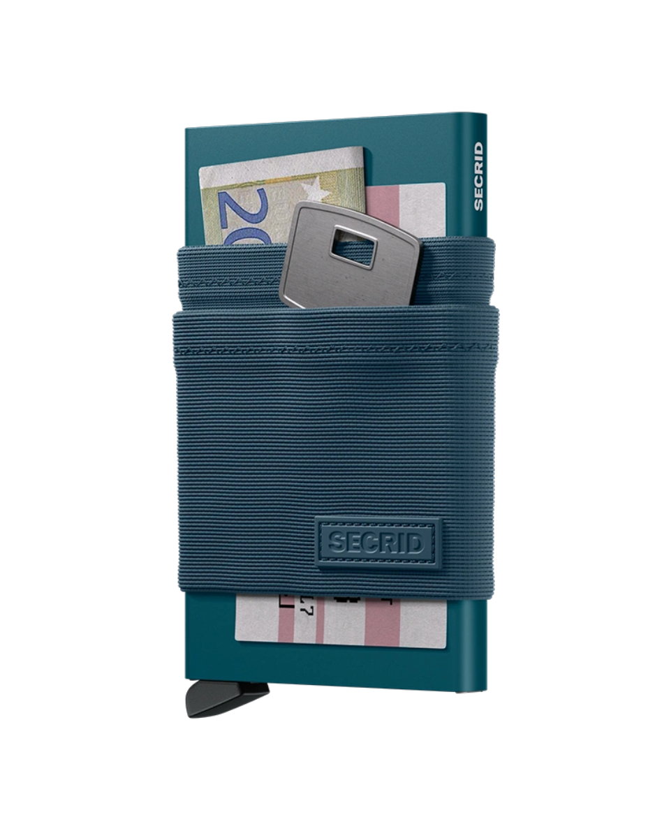 Sedel och nyckel placerade i textilfickan på Secrid Flexwallet Teal.